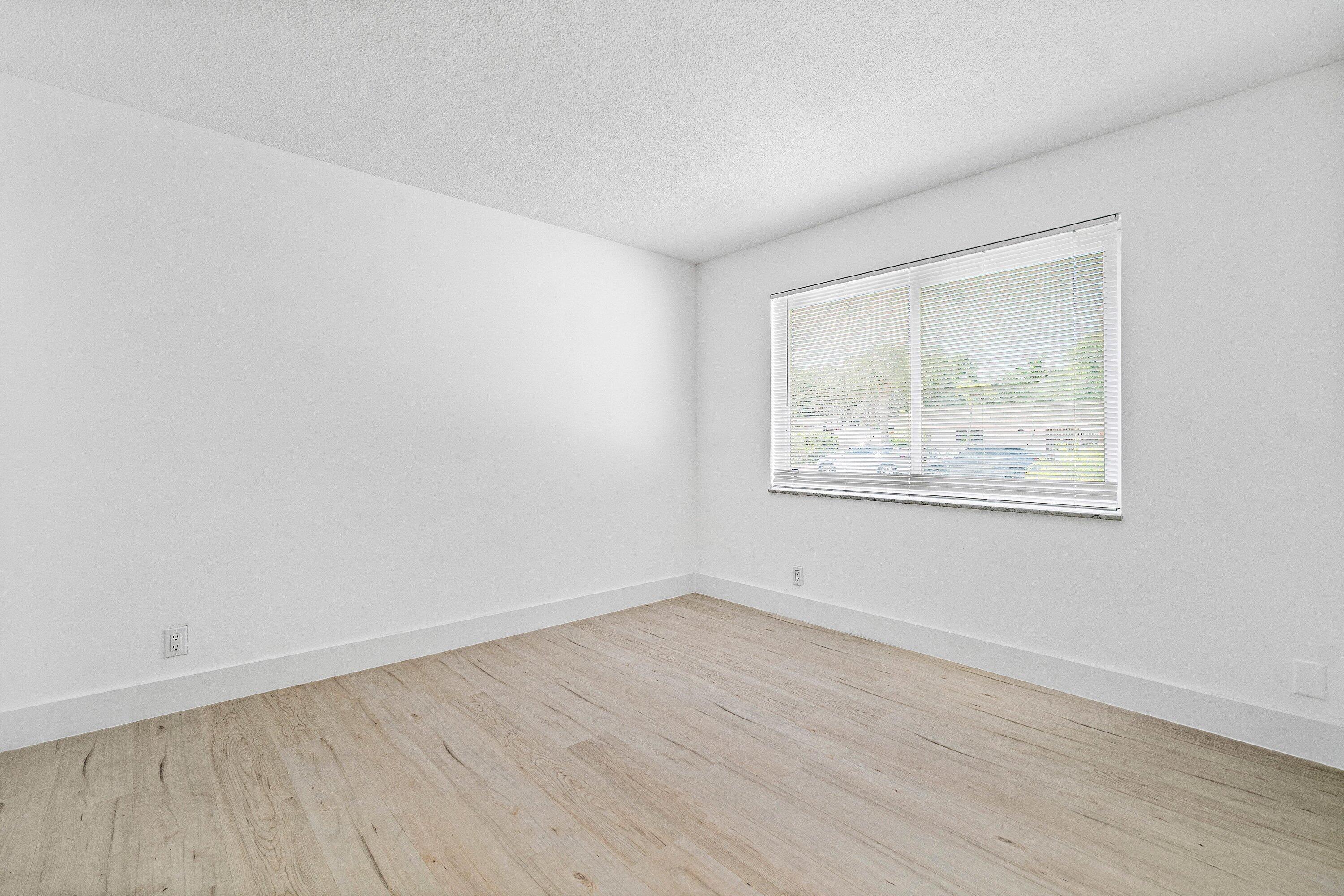 1531 Northwest 4th Street Boca Raton, FL 33486 - Photo 21 of 34 an empty room with wooden floor and windows