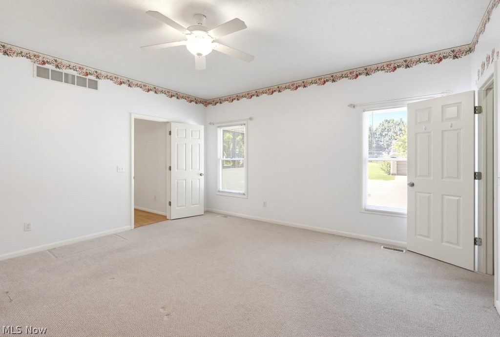 2331 Call Road Stow, OH 44224 - Photo 12 of 18 Spacious Owners Suite- Featuring abundant natural lighting, ceiling fan and a private on suite bath for added comfort.