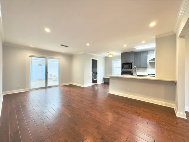 a view of kitchen with cabinets and wooden floor