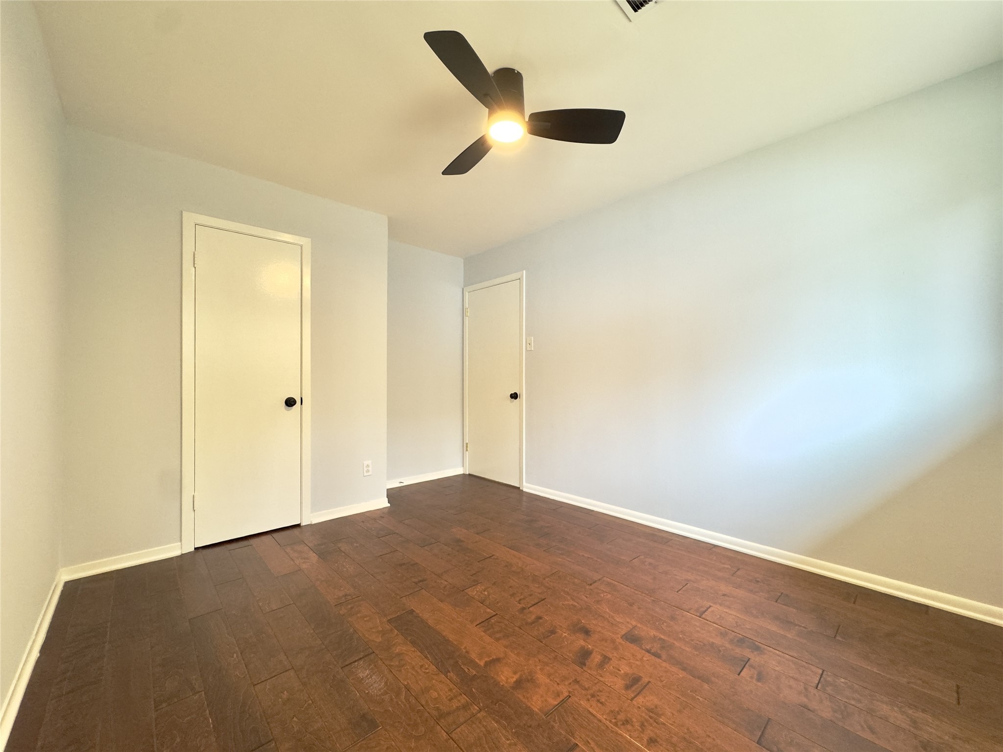 1415 Mapleton Drive Houston, TX 77043 - Photo 21 of 45 an empty room with ceiling fan and window