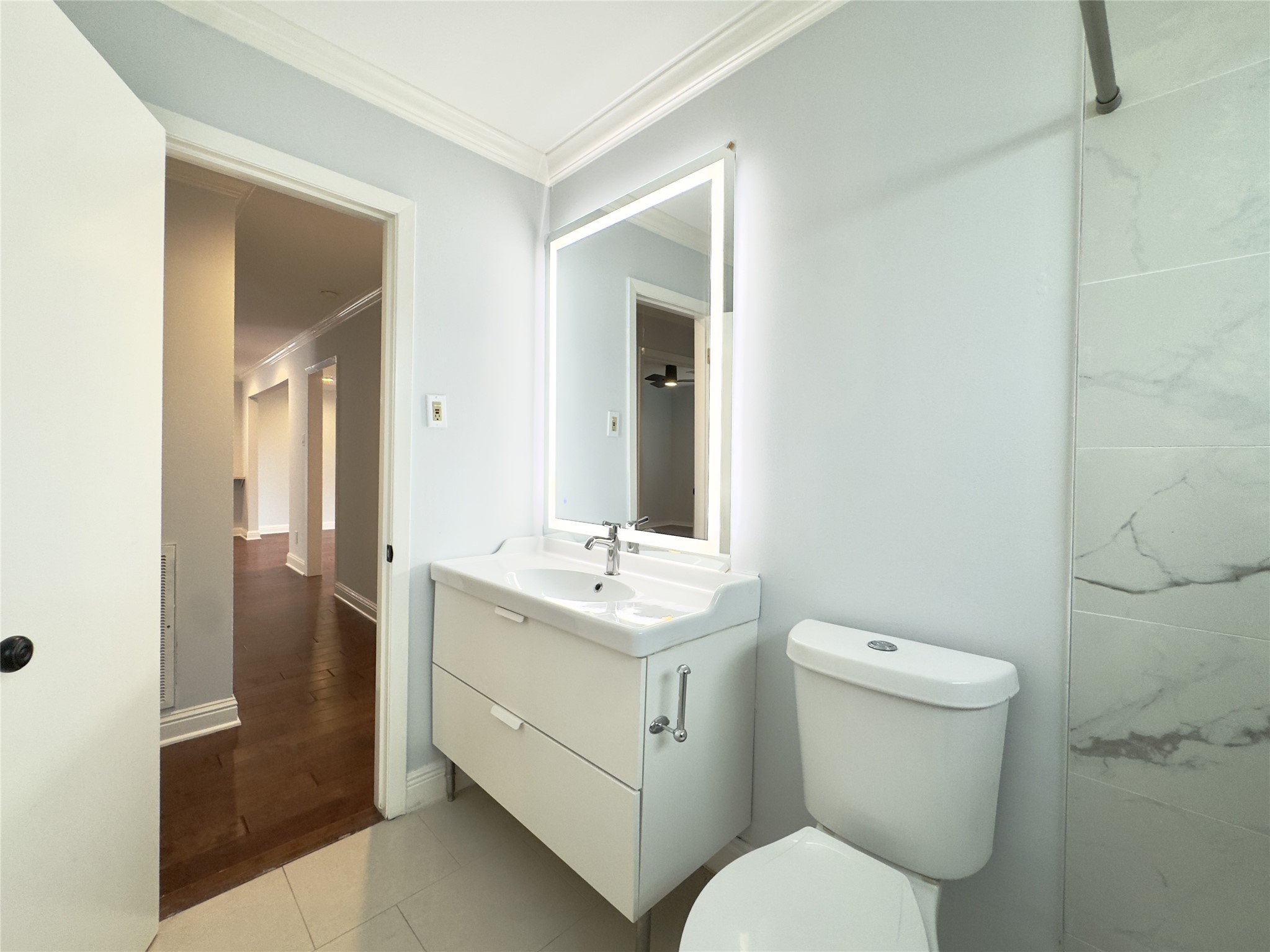 1415 Mapleton Drive Houston, TX 77043 - Photo 23 of 45 a bathroom with a toilet sink and mirror