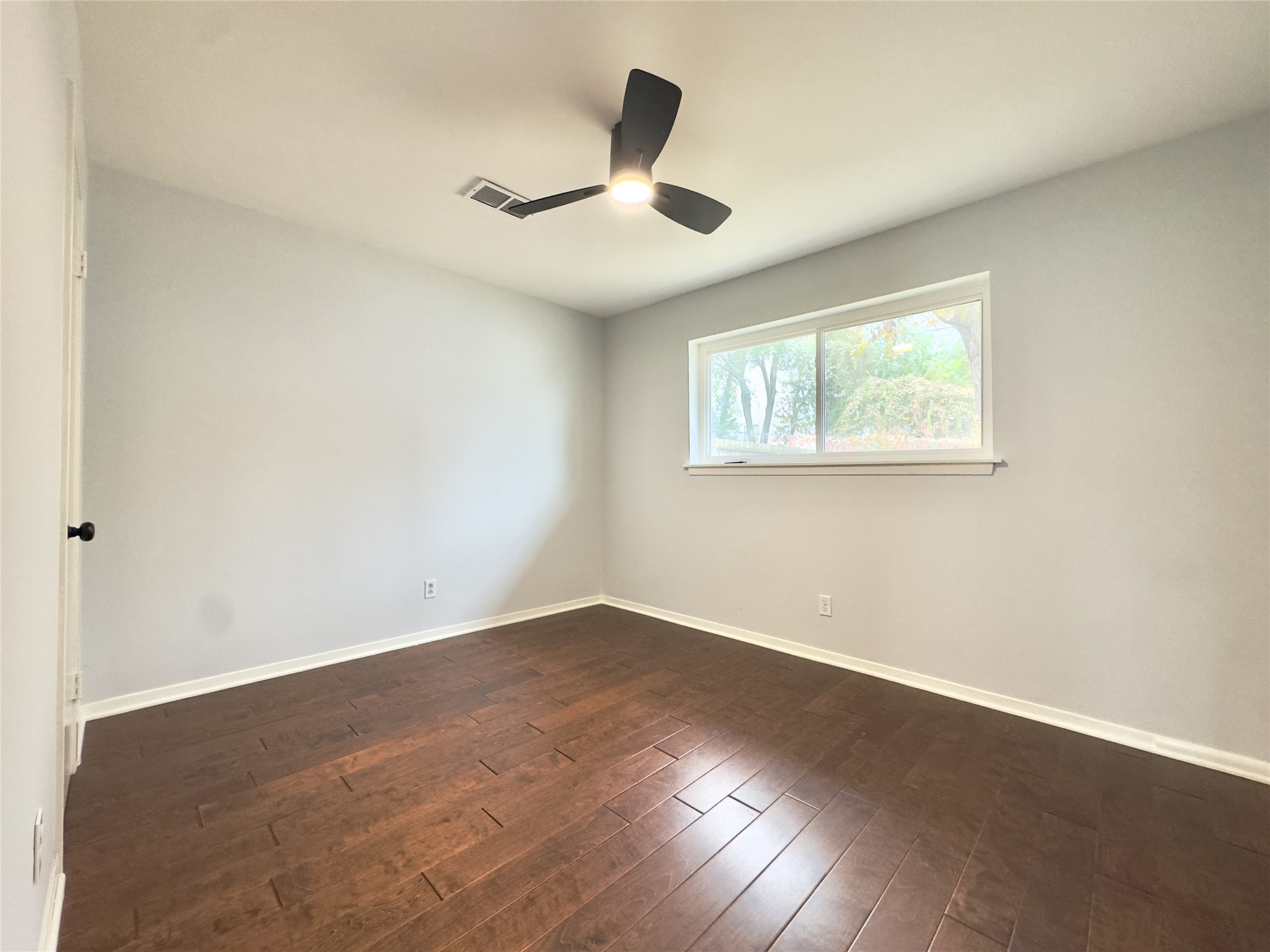 1415 Mapleton Drive Houston, TX 77043 - Photo 24 of 45 an empty room with wooden floor and windows