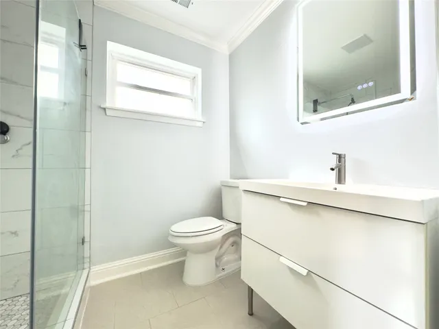 a bathroom with a sink toilet and mirror