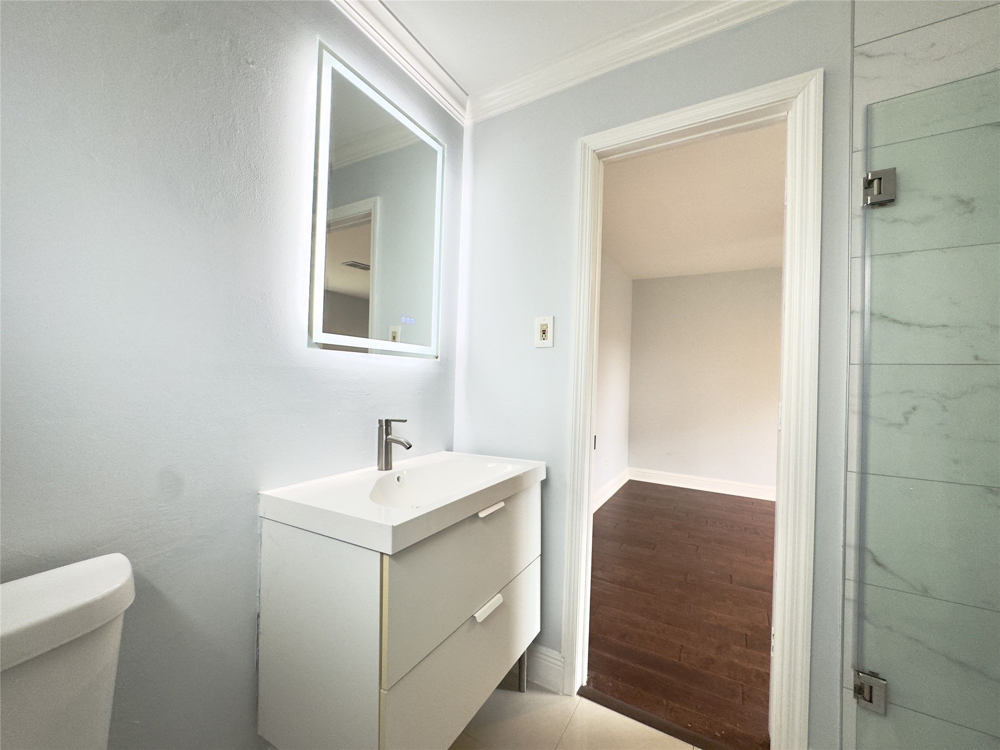 1415 Mapleton Drive Houston, TX 77043 - Photo 26 of 45 a bathroom with a sink toilet and mirror
