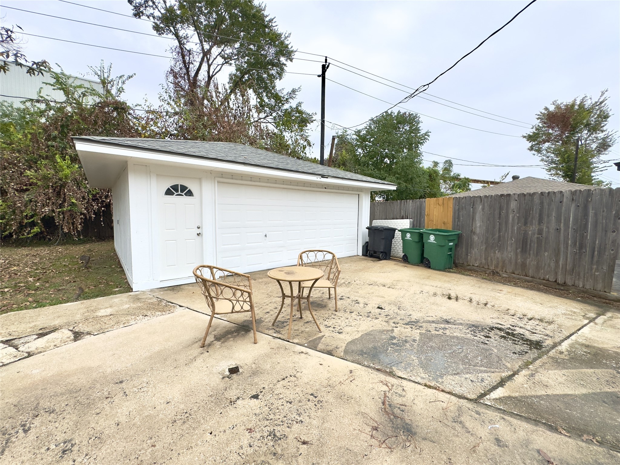 1415 Mapleton Drive Houston, TX 77043 - Photo 34 of 45 a view of a patio with table and chairs with wooden fence and plants