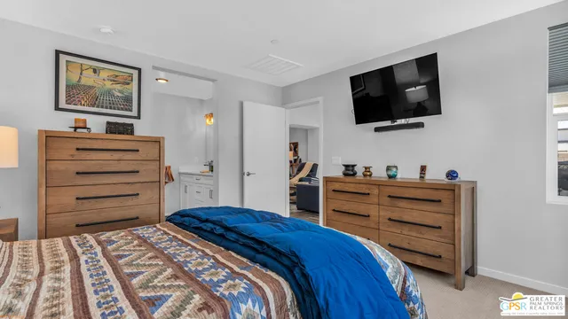 a bed room with a bed and a television