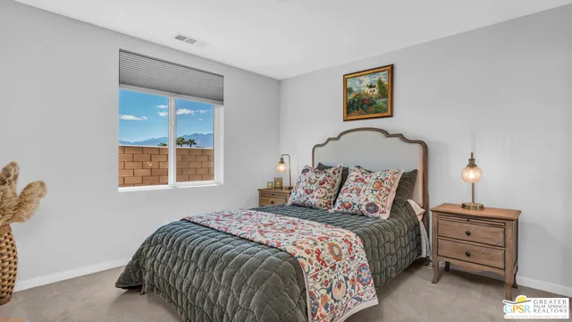 a bedroom with a bed and a painting on the wall