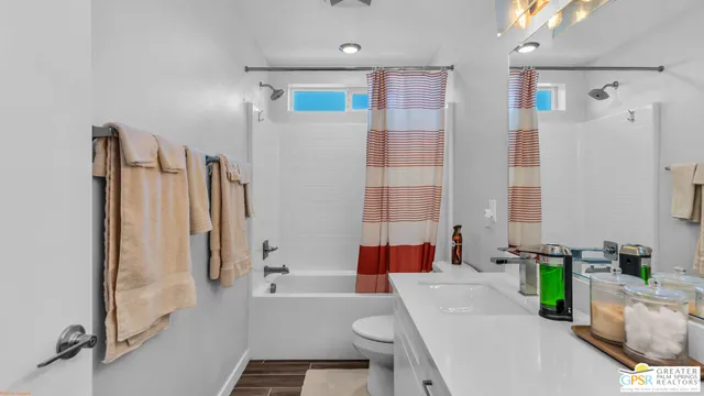 a bathroom with a tub sink and a mirror