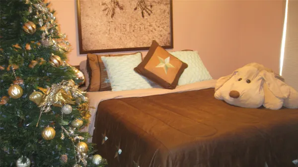 a bedroom with a bed and a night stand