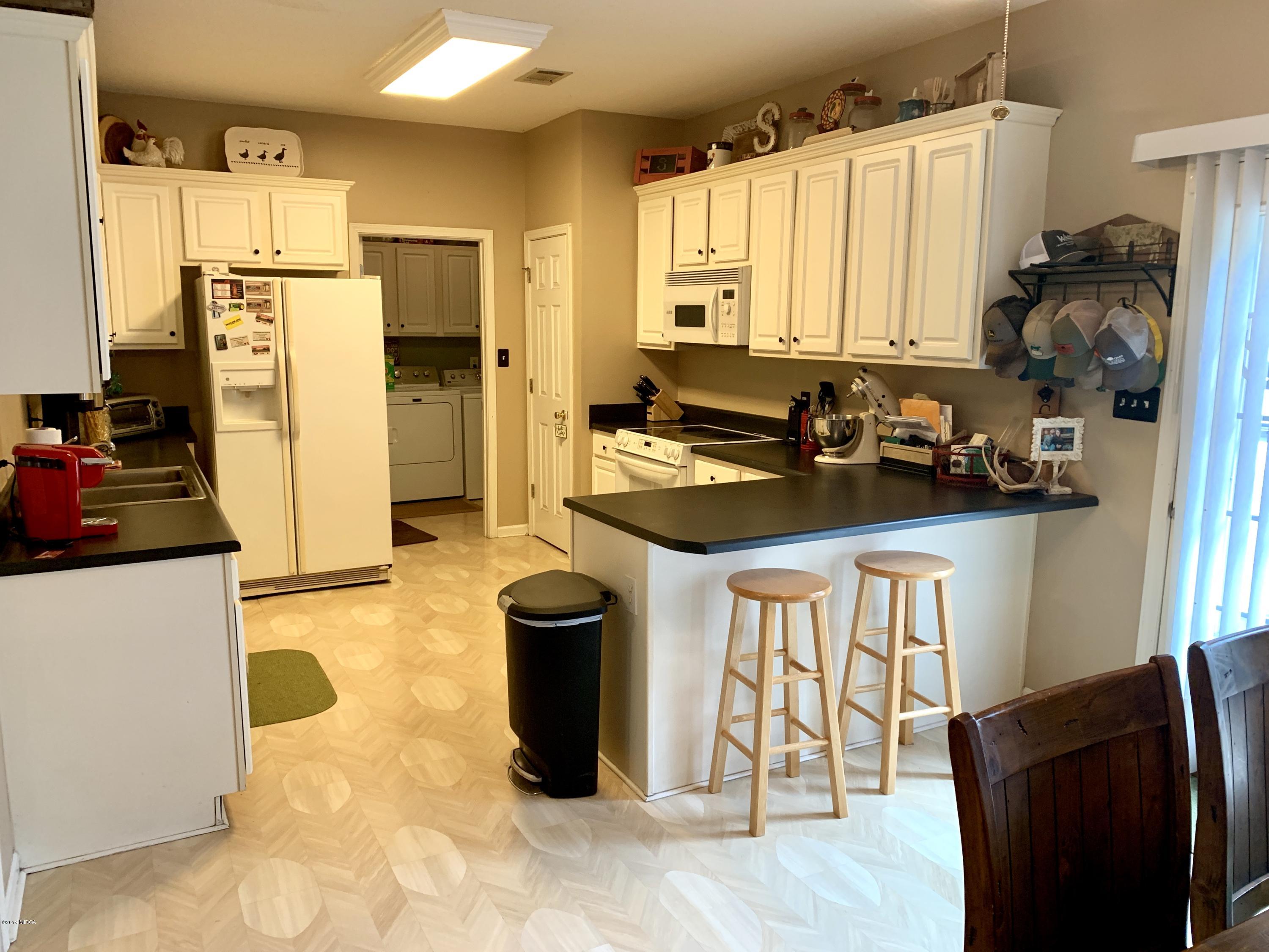 1325 Taylor Road Juliette, GA 31046 - Photo 16 of 18 a kitchen with a refrigerator and a stove top oven