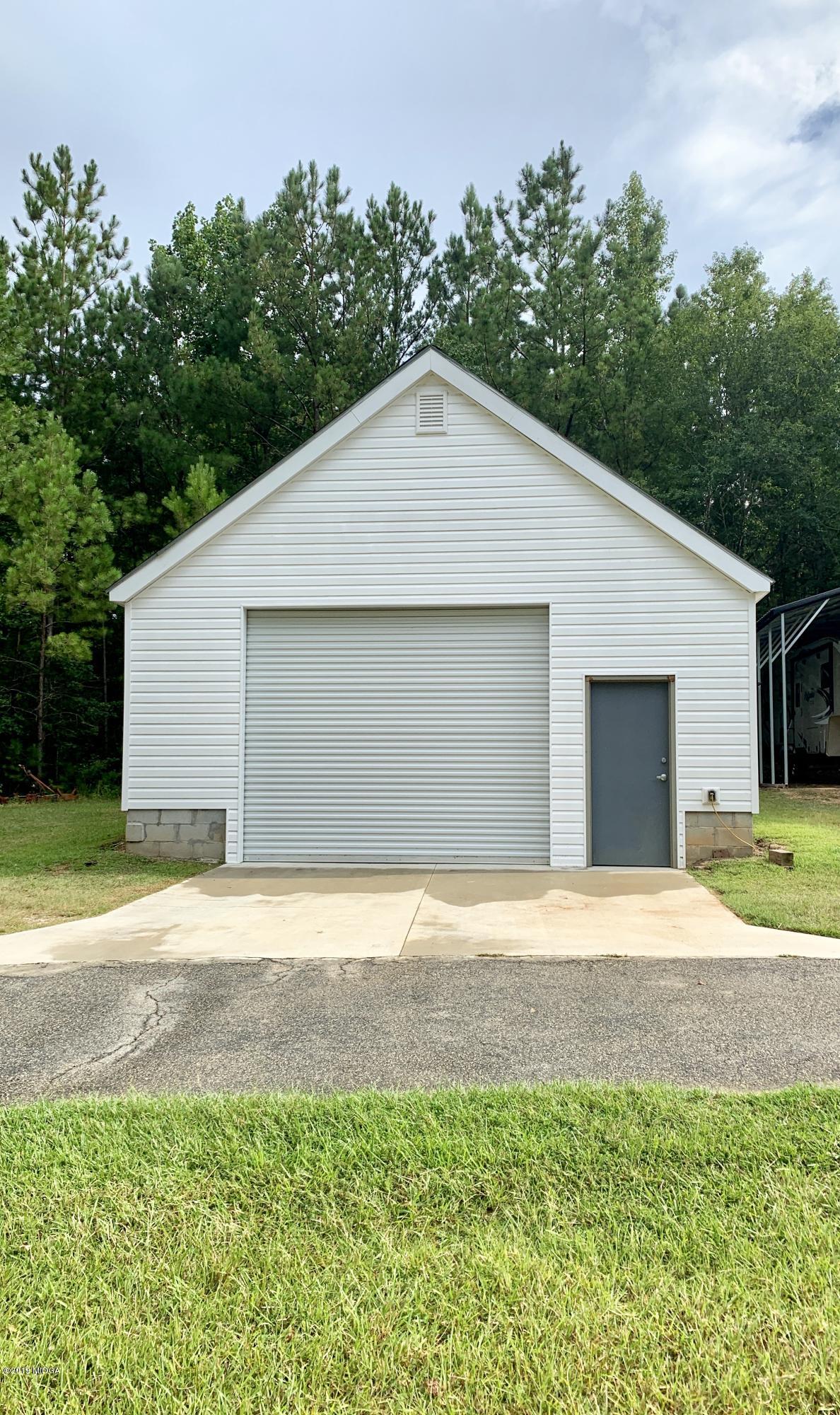 1325 Taylor Road Juliette, GA 31046 - Photo 17 of 18 a front view of a house with a yard and garage