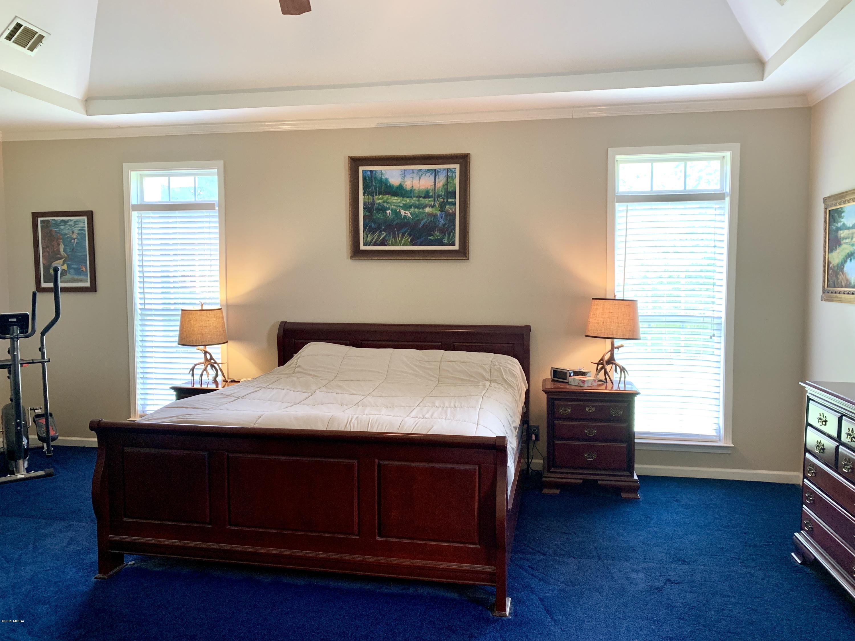 1325 Taylor Road Juliette, GA 31046 - Photo 18 of 18 a bedroom with a bed and a lamp on dresser