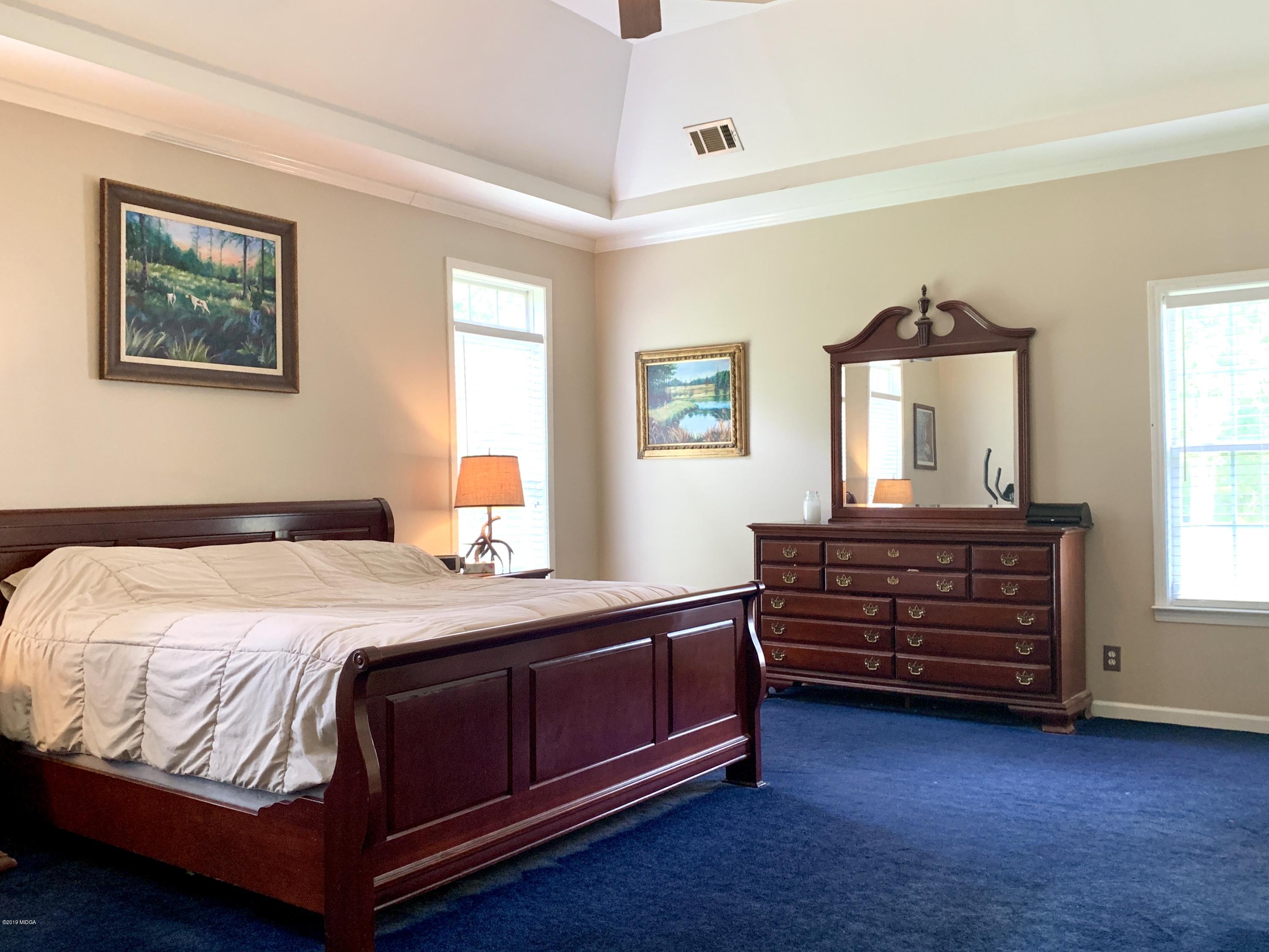 1325 Taylor Road Juliette, GA 31046 - Photo 8 of 18 a bedroom with a bed and wooden floor