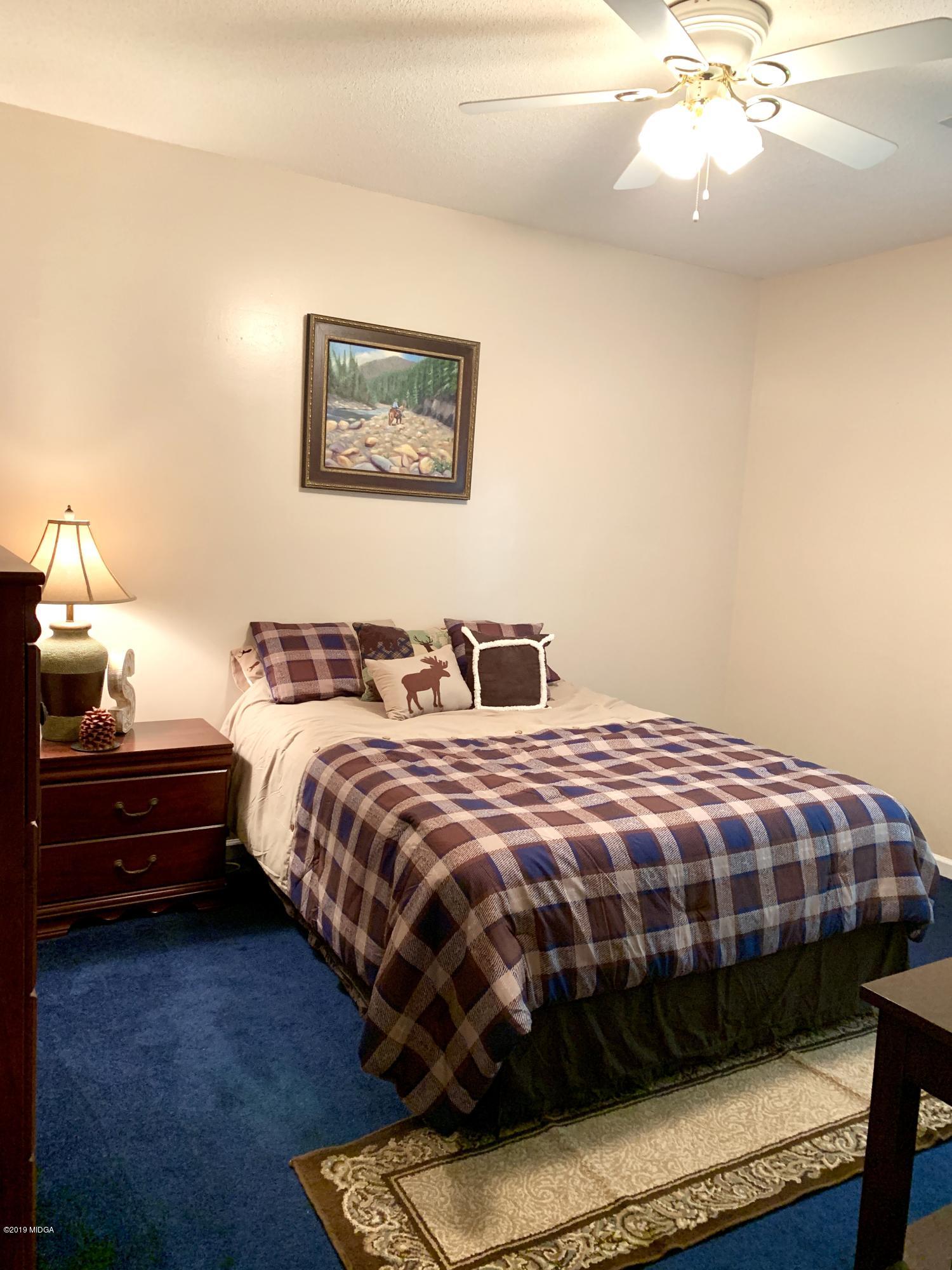 1325 Taylor Road Juliette, GA 31046 - Photo 9 of 18 a bedroom with bed and a chandelier