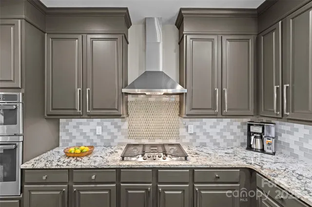 a kitchen with granite countertop cabinets and window