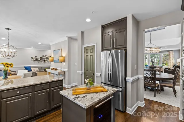 a kitchen with stainless steel appliances granite countertop sink stove and refrigerator