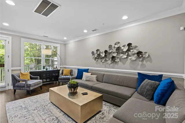 a living room with furniture window and wooden floor