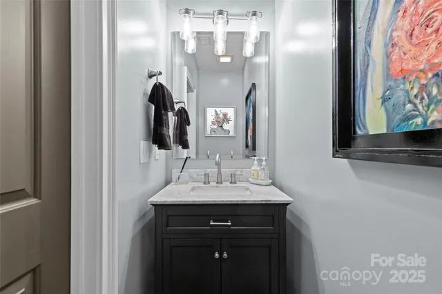 a bathroom with a sink vanity and mirror