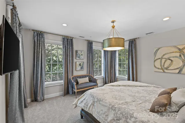 a bedroom with a bed and a chandelier