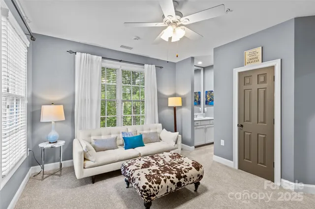 a bedroom with furniture and a large window