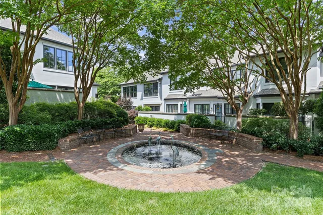 a front view of a house with yard and green space
