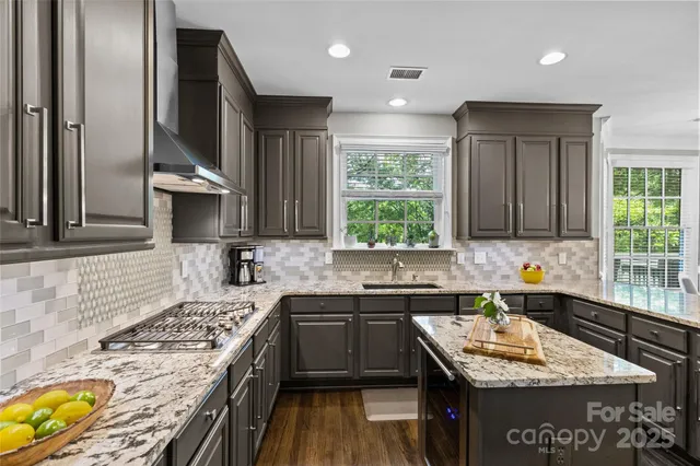 a kitchen with a sink stove and cabinets