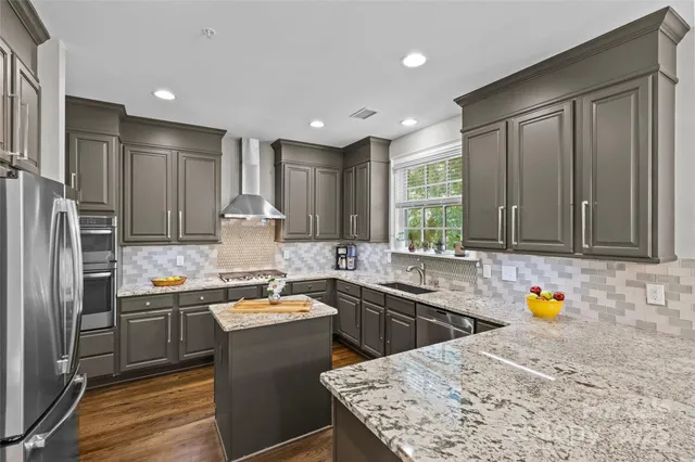 a kitchen with a sink stove and refrigerator