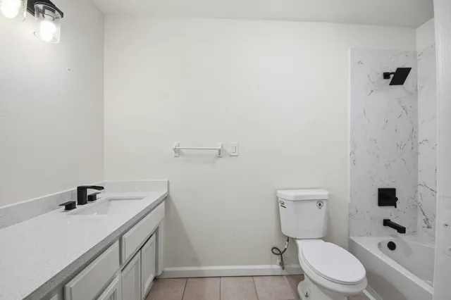 a white toilet sitting next to a bathroom sink