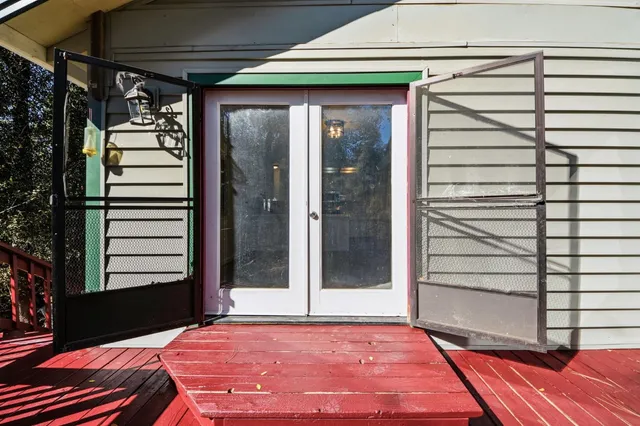 a view of a porch with a table and chairs