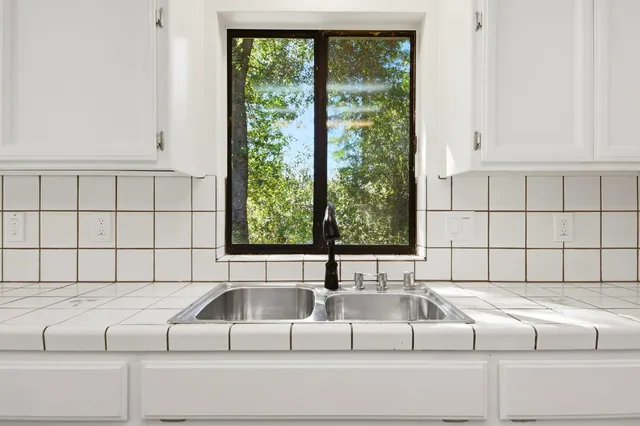 a living room with furniture and large window