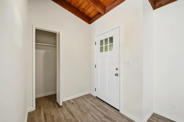 a view of an empty room with wooden floor