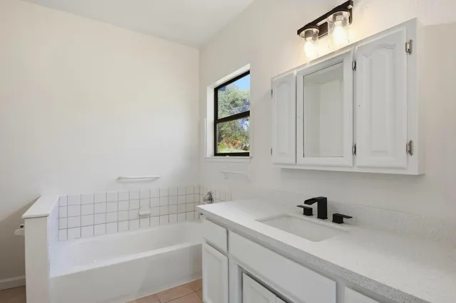 a bathroom with a bathtub and a sink
