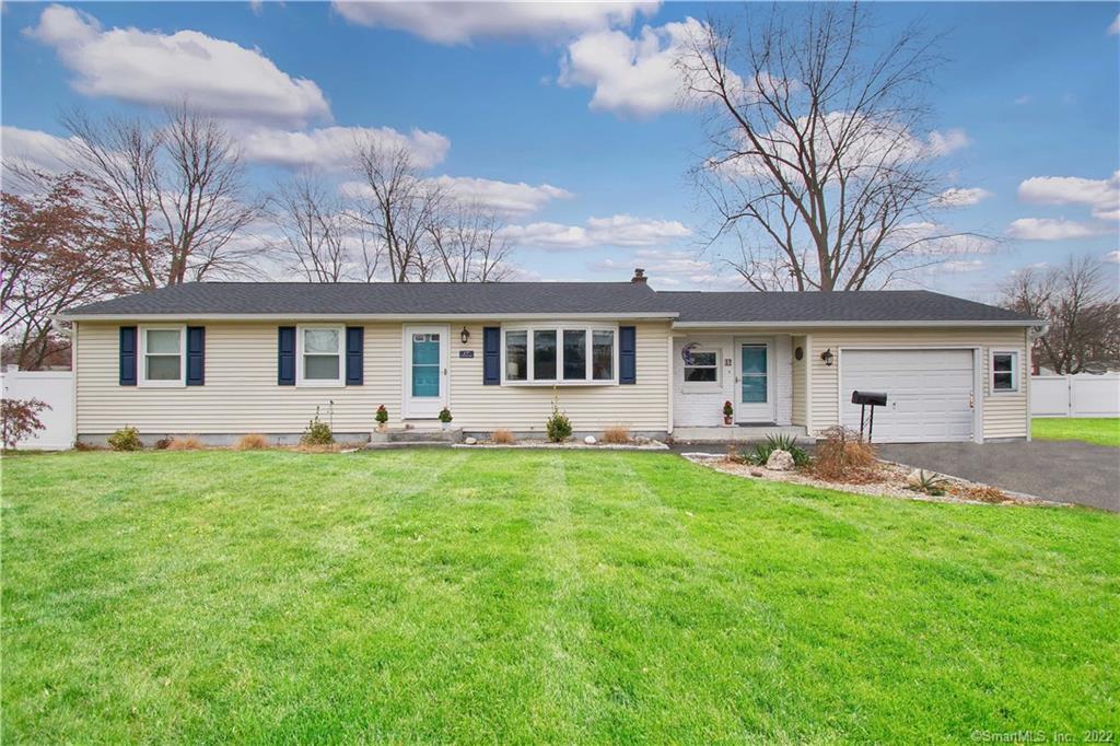 a front view of a house with a yard and patio