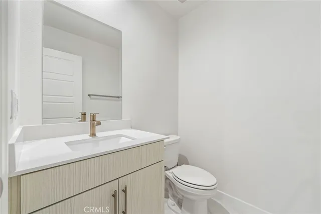 a bathroom with a sink a toilet and mirror
