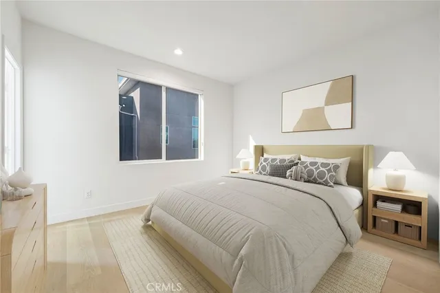 a bedroom with a large bed and a night stand