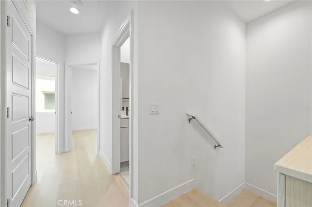 a view of a hallway with a glass shower door