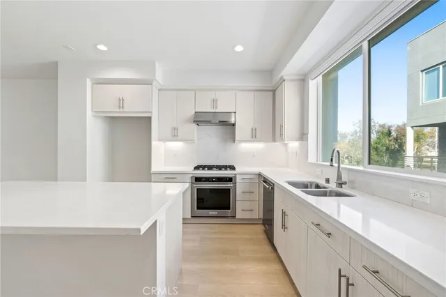 a kitchen with a sink stove and cabinets