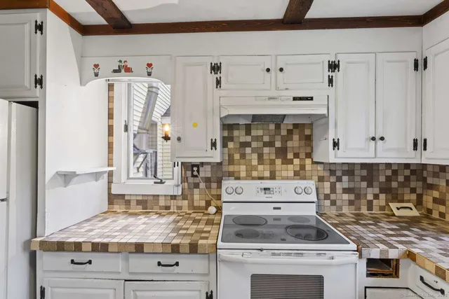 a kitchen with stainless steel appliances granite countertop a stove and a refrigerator