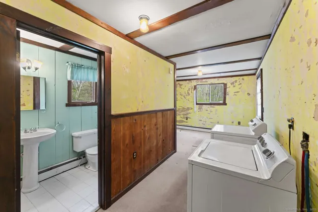 a bathroom with a toilet sink and mirror