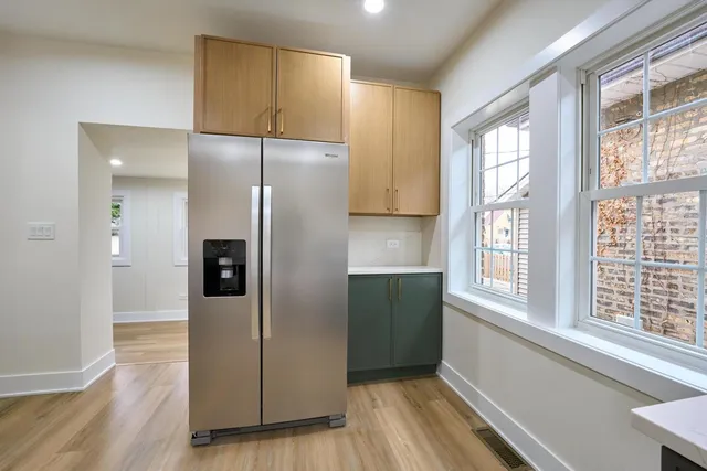 a kitchen with a refrigerator and a sink