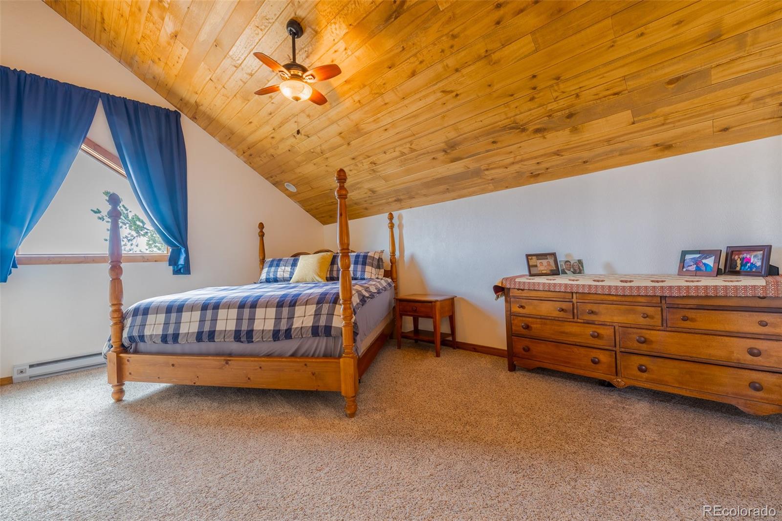 8221 Remington Road Como, CO 80432 - Photo 29 of 49 a bedroom with furniture and a chandelier