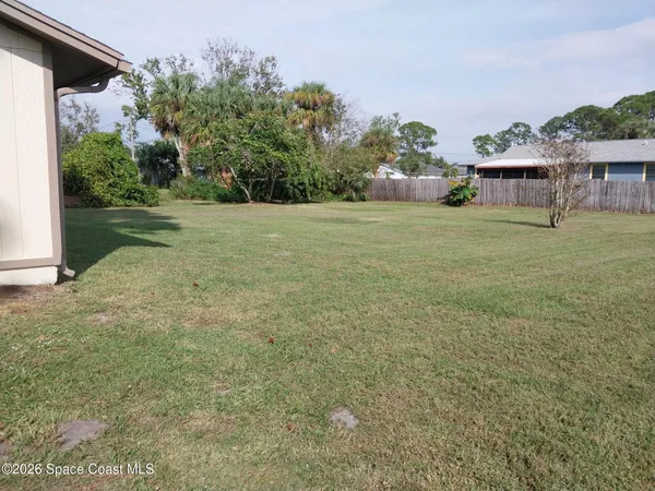 a view of house with backyard