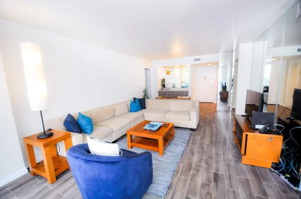 a living room with furniture and wooden floor