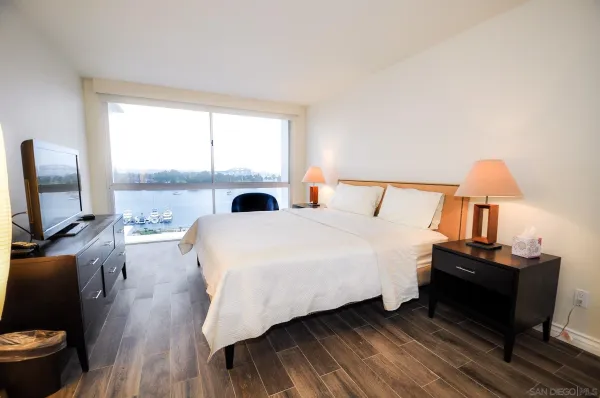 a bedroom with a bed and a flat screen tv