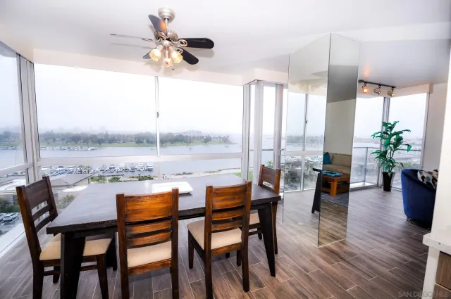 a dining room with furniture window and wooden floor