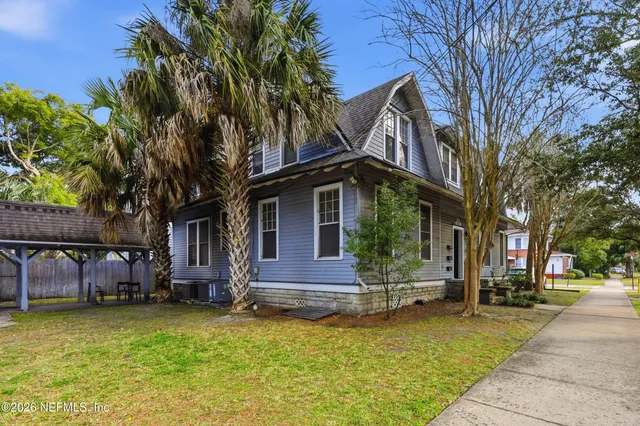 a front view of a house with a yard garage and outdoor seating