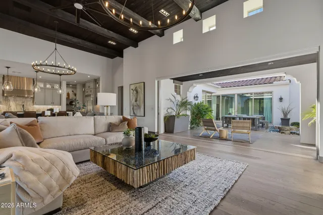 a kitchen with stainless steel appliances kitchen island granite countertop a table chairs in it and white cabinets