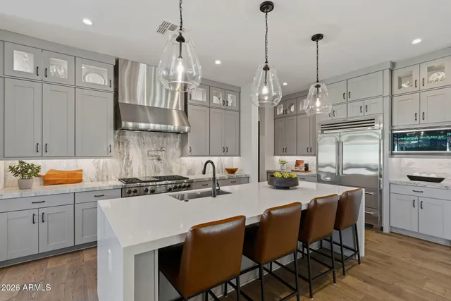 a kitchen with stove a sink and a refrigerator