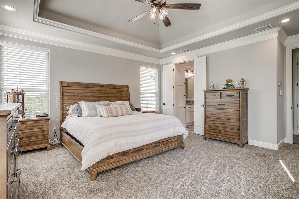 2161 Eagles Rdg Drive Weatherford, TX 76087 - Photo 18 of 40 a spacious bedroom with a bed and a ceiling fan