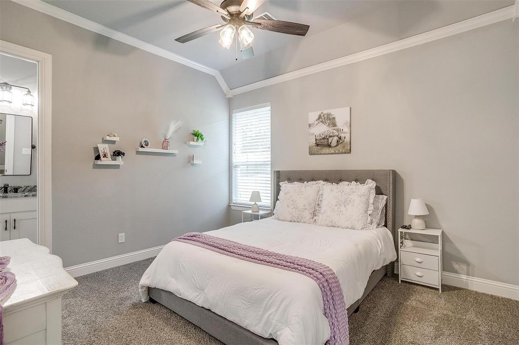 2161 Eagles Rdg Drive Weatherford, TX 76087 - Photo 25 of 40 a bedroom with a large bed and a chandelier